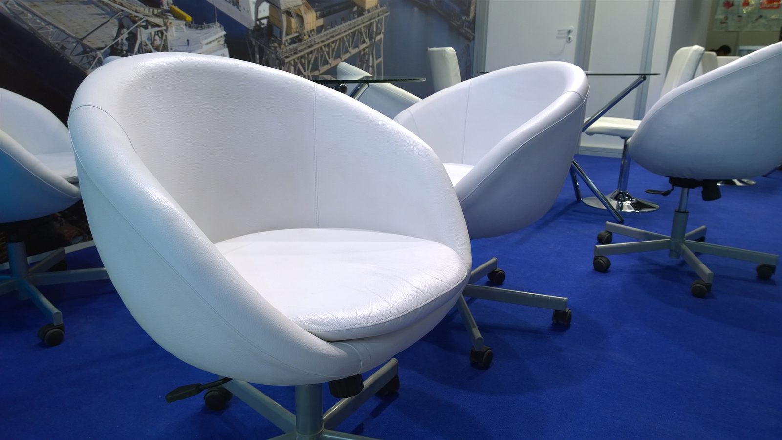 White swivel chairs around a table in a meeting room