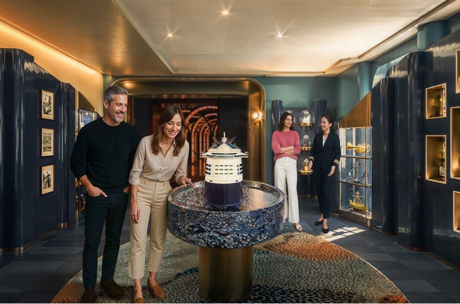 Guests gathered around a display in a dark wood lounge on a ship